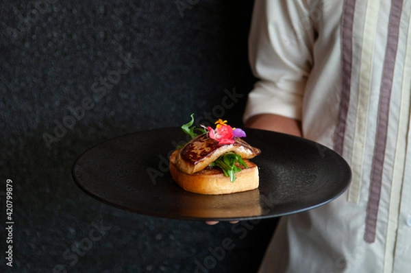 Fototapeta Foie Gras serving with toasted bread and green salad