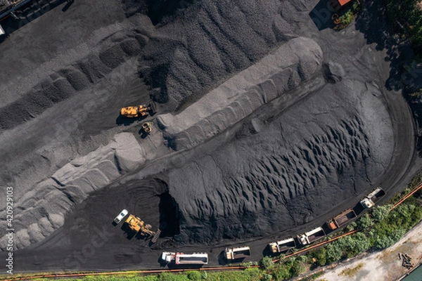 Obraz Top down aerial view of coal and trucks lined up for loading