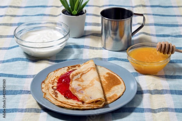 Fototapeta pancakes with jam, sour cream and honey