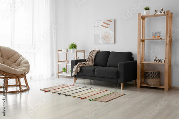 Fototapeta Interior of modern room with comfortable black sofa