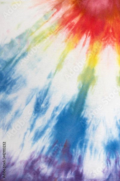 Fototapeta Pastel tie dye, a handmade pattern on a cotton t-shirt. Close-up, top view. DIY concept, handicrafts, original everyday clothes, fabric dyeing techniques. Flat lay, Vertical. Abstract background