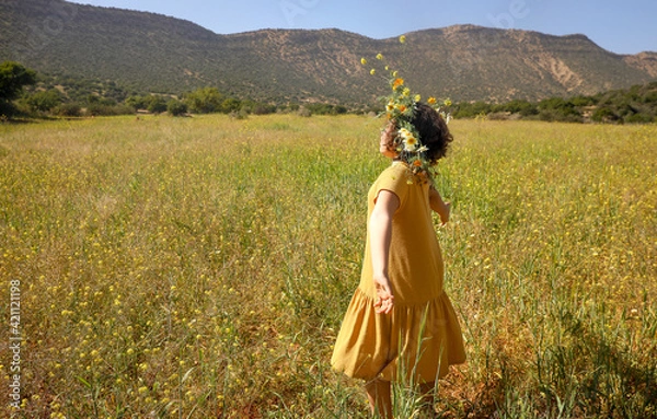 Fototapeta Girl with wreath on head in the field.