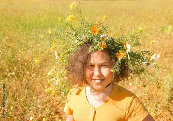 Fototapeta Girl with wreath on head in the field.