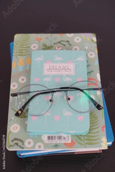 Fototapeta Glasses on a notebook