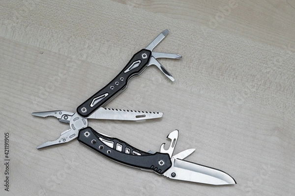 Fototapeta Selective focus of unfolded Leatherman pocket multi tools. Easy to use for daily purposes 