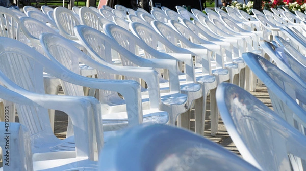 Fototapeta Array of empty white chairs