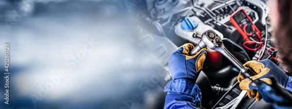 Obraz Auto mechanic working on car broken engine in mechanics service or garage.