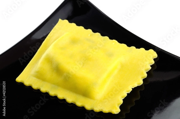Obraz Ravioli filled with spinach and ricotta on a black plate