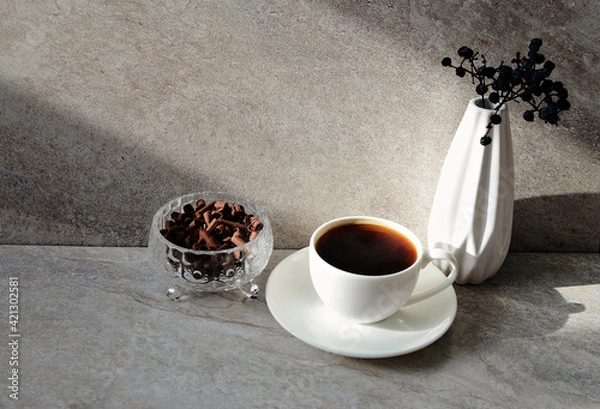 Fototapeta White  cup of coffee, vase, chocolate curls on grey marble background, copy space.