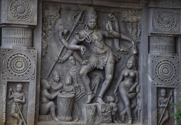 Fototapeta Stock photo of intricate sculpture of Indian lord shiva, carved out of stone in ancient hindu temple at Kolhapur city Maharashtra India. focus on object.