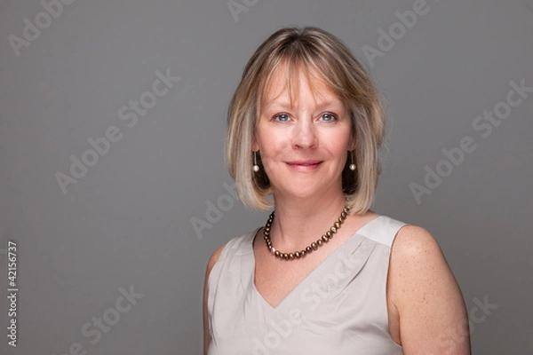 Fototapeta Head Shot of Attractive Smiling Elegant Woman on Grey Background