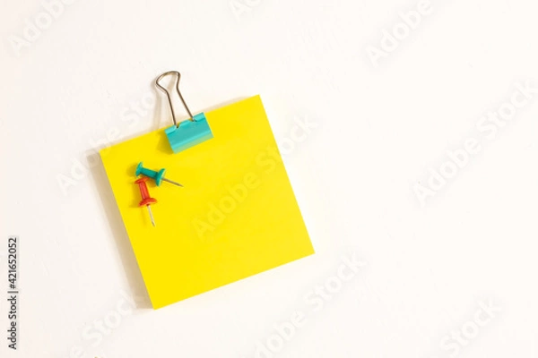 Fototapeta Green Binder Clips, Pins and Yellow Sticky Notes Isolated on White background. School and Business Concept