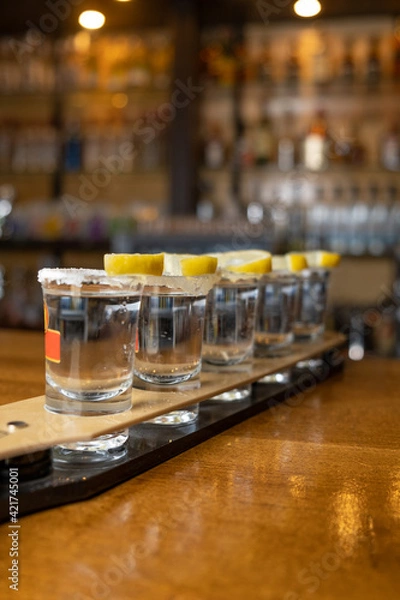Obraz tequila lined up on bar desk