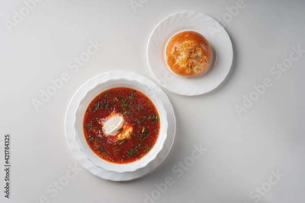 Obraz Borscht with sour cream in a white plate top view