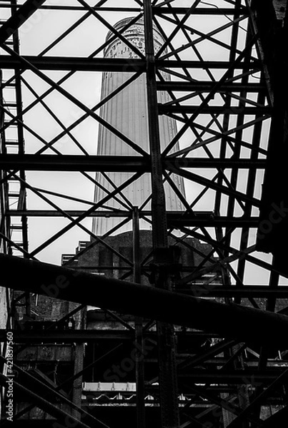 Obraz Close-up of an Old Rusty Metal Frame With a Chimney in the Background
