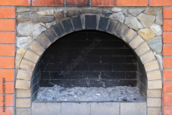 Fototapeta The small brick furnace and soot in it