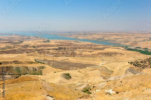 Fototapeta A patchwork of fields showing harvested grain crops which lie adjacent to Ataturk Dam (GAP) near Samsat in the Adiyaman Province of eastern Turkey.