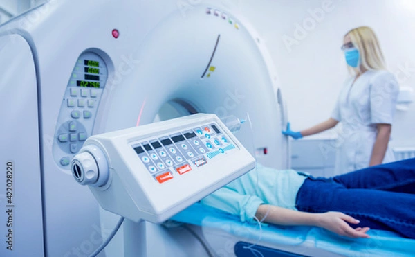 Obraz Radiologist with a female patient in the room of computed tomography