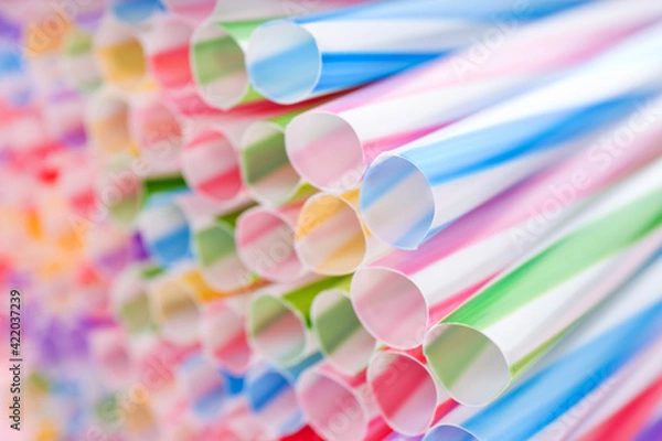 Fototapeta Heap of colorful plastic straws for drinks as background, closeup
