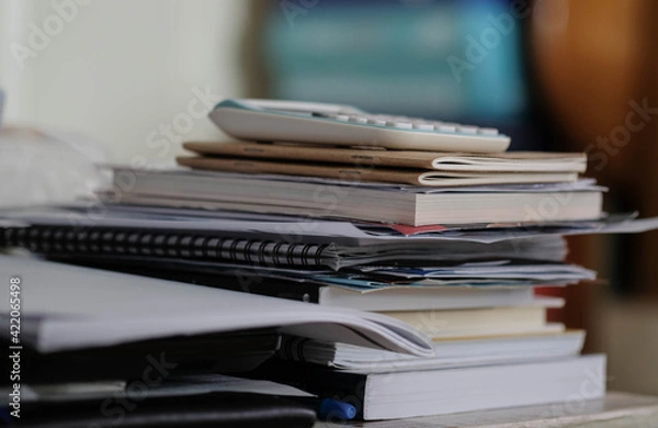 Fototapeta Stacked books and documents on the table