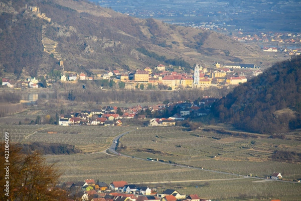 Fototapeta A view from Weißenkirchen over vineyards and Dürnstein ruins in the early spring on a sunny day from above