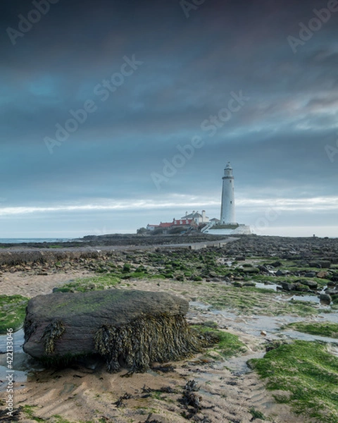 Obraz Whitley Bay on the north east coast of England, UK. Looking towards St Marys Lighthouse over the causeway on an overcast morning at dawn.