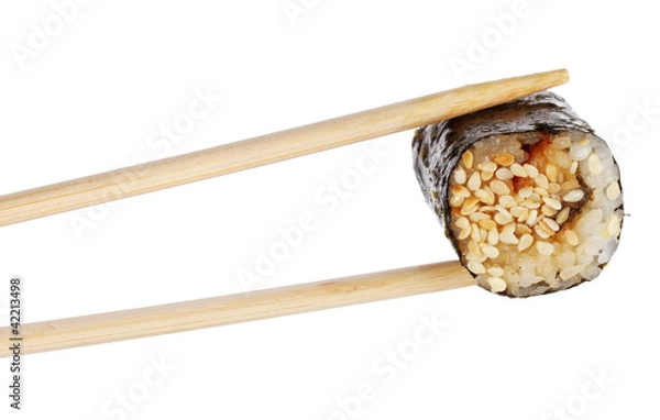 Fototapeta Holding roll with chopsticks isolated on white