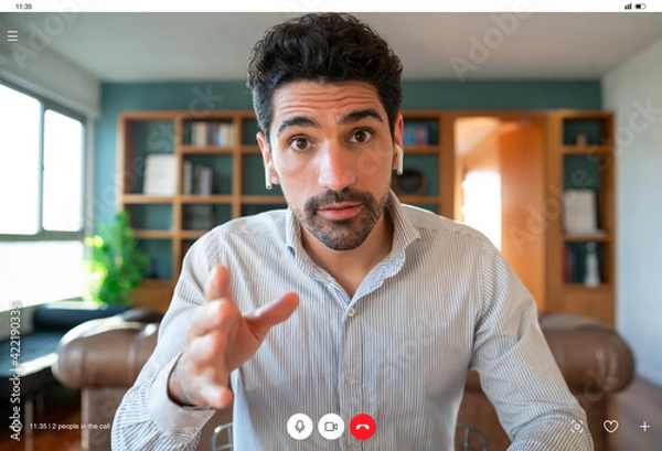Obraz Business man on a work video call from home.