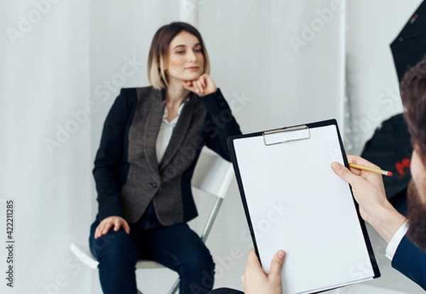 Fototapeta Woman for job interview and man with documents in the foreground
