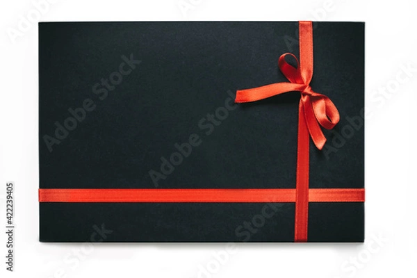 Obraz Black gift box with the red ribbon isolated on white
