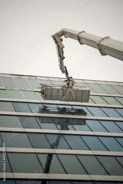 Fototapeta Crane on a building. Window cleaning in progress.