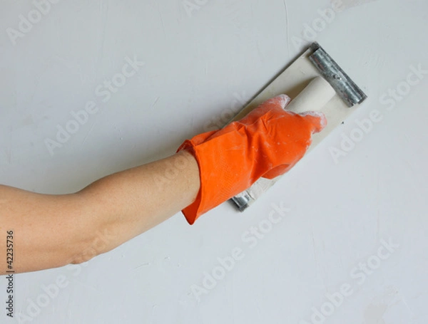 Obraz Plasterer smoothing out wall with trowel