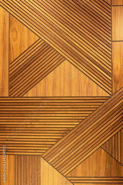 Fototapeta Designer walnut veneer panel, geometric crisscross pattern wood wall. Architectural background, texture. The concept is a modern interior, natural materials, minimalism style. Vertical