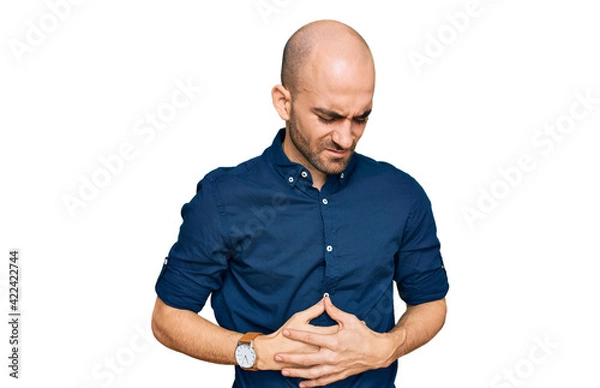 Obraz Young hispanic man wearing casual clothes with hand on stomach because indigestion, painful illness feeling unwell. ache concept.