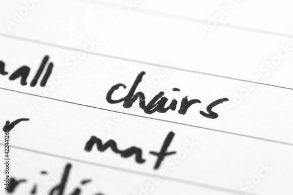 Obraz Macro shot of hand writing on paper using pen