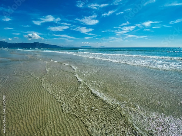 Obraz Tropical vacation concept. Soft long waves on the tropical shore of a long empty sea beach. Caribbean coast