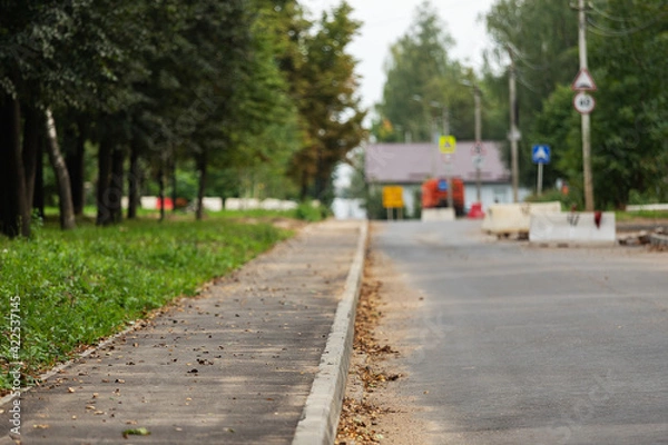 Fototapeta poorly executed road repairs. replacing the old curb stone with a new one