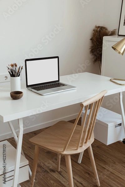 Fototapeta Laptop computer with blank screen on table. Aesthetic minimal office workspace interior design template with mockup copy space.