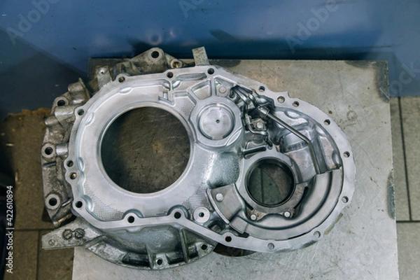 Fototapeta Set of various engine and gearbox spare parts. Shiny gears for planetary gearbox.Metal autotechnology background. wheel engine gears, close up. Automatic transmission in section