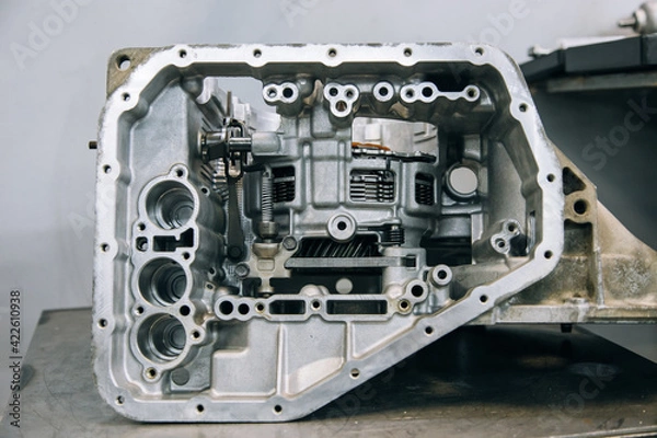 Fototapeta Set of various engine and gearbox spare parts. Shiny gears for planetary gearbox.Metal autotechnology background. wheel engine gears, close up. Automatic transmission in section