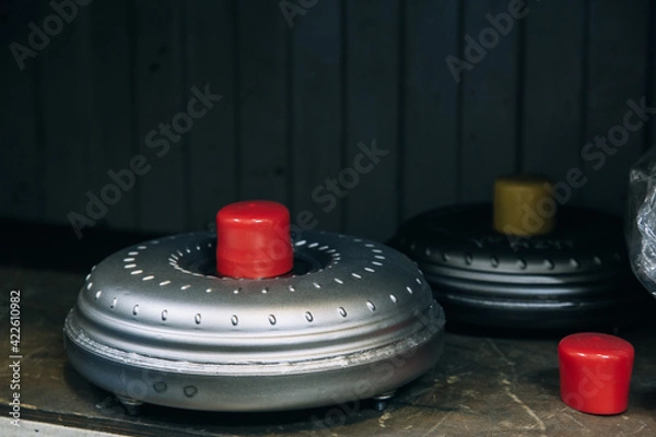 Fototapeta Set of various engine and gearbox spare parts. Shiny gears for planetary gearbox.Metal autotechnology background. wheel engine gears, close up. Automatic transmission in section