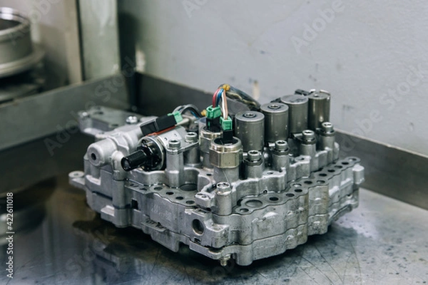 Fototapeta Set of various engine and gearbox spare parts. Shiny gears for planetary gearbox.Metal autotechnology background. wheel engine gears, close up. Automatic transmission in section