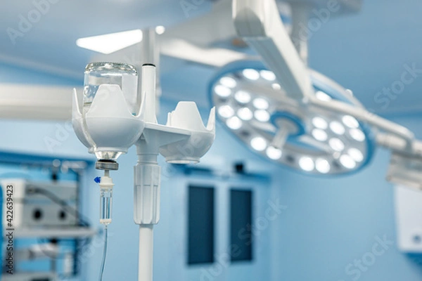 Fototapeta A dropper with medication in the operating room against the background of medical equipment.