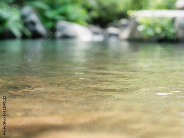 Fototapeta Abstract view of water surface of calm mountain stream with shallow depth of field