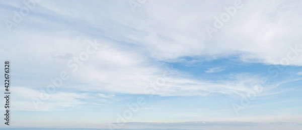Obraz Blue sky against soft white clouds. Beautiful natural cloudscape background.
