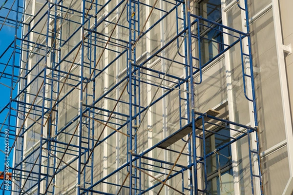 Obraz Scaffolding installed next to the building to repair the building.