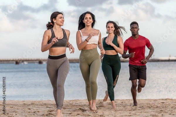 Obraz Happy diverse man and women running on beach