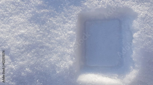 Fototapeta Winter background with snow close-up, top view. On a sunny day outdoors. Pure and shiny snow, with highlights and shadows. Loose gray snow, natural texture. Copy space, no people, attachment frame.