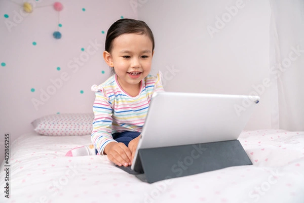 Obraz Girl child watching content in digital tablet.