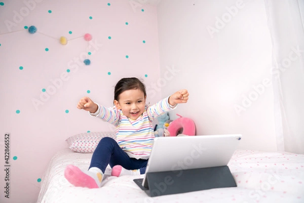 Fototapeta Happy little girl winning a game.